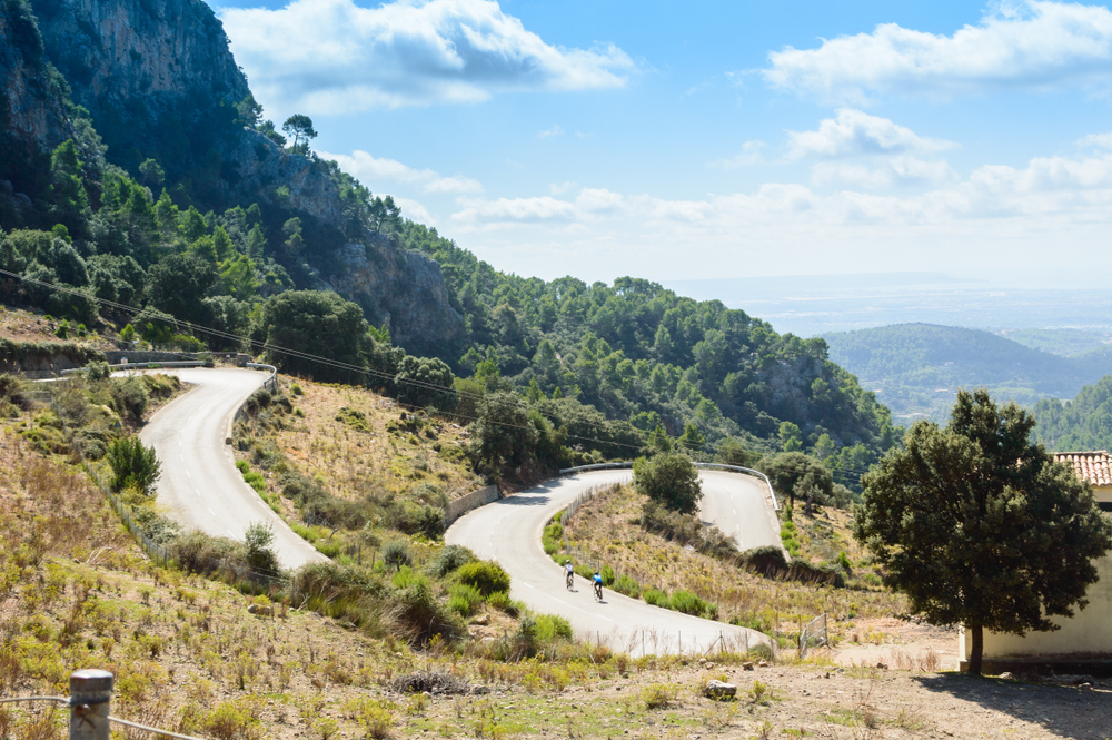 Cyclists cross the serpentine road of the Sierra of Tramontana, on the Island of Mallorca